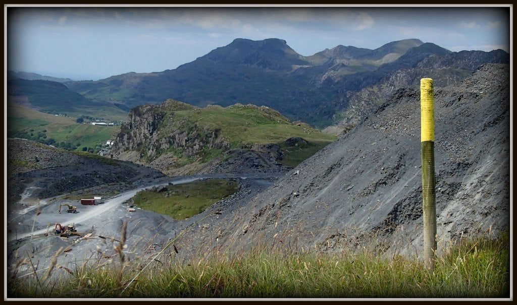 Slate waste heaps overlook quarry workings and the Moelwyn mountains near Blaenau Ffestiniog in Snowdonia.