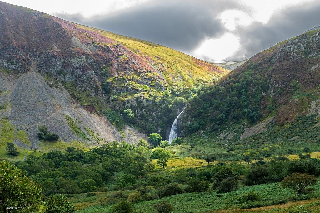Aber Falls cascades between steep green hillsides at the head of the Aber Valley in Snowdonia.